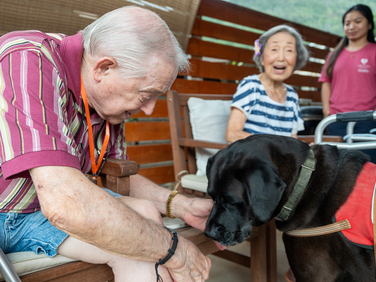 image of residents Valley Comfort Care Home playing with the staff dog.